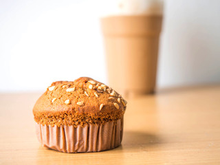 Peanuts on top of Banana cake on a brown and white Background.