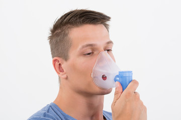 Man Inhaling Through Inhaler Mask