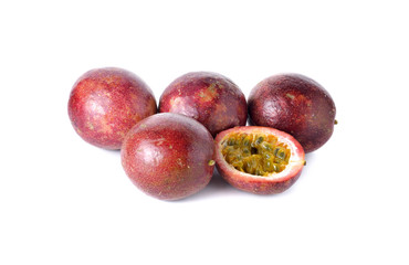 whole and half cut passion fruits on white background