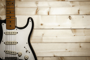 Old Electric Guitar on the Wood Background
