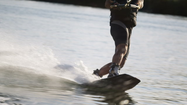 man on a wakeboard behind a boat