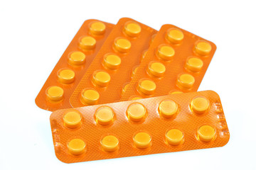 yellow pills on white background