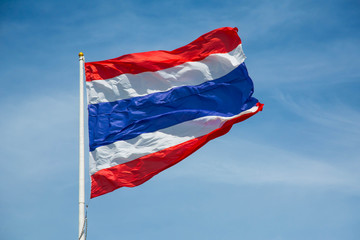 Fototapeta na wymiar Waving Thai flag of Thailand with blue sky background