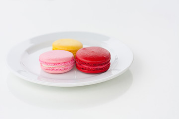 Sweet and colourful french macarons on white table