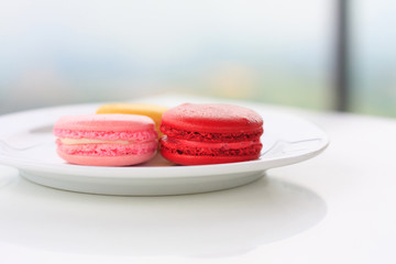 Sweet and colourful french macarons on white table