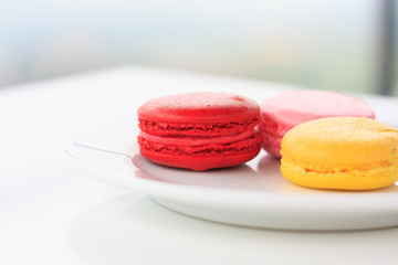 Sweet and colourful french macarons on white table