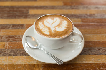 Hot art Latte Coffee in a cup on wooden table