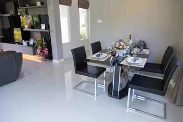 Dining table with set in modern home, Wooden table in Dining room, Luxury corner in the family. modern home designed, modern life in modern home, creative home designed, beautiful interior design.