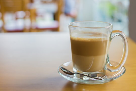 hot latte coffee on wooden table, vintage and retro style