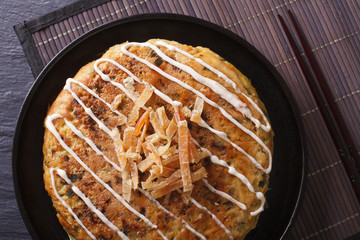 Japanese food: okonomiyaki close-up on a plate. horizontal top view
