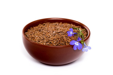 isolated bowl with flax seeds and flax flower
