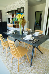 Dining table with set in modern home, Wooden table in Dining room, Luxury corner in the family. modern home designed, modern life in modern home, creative home designed, beautiful interior design.
