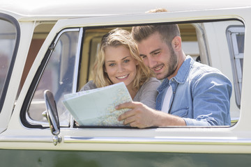 young couple with vintage camper van