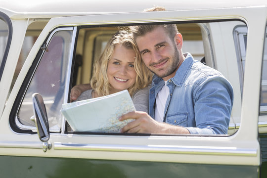 young couple with vintage camper van