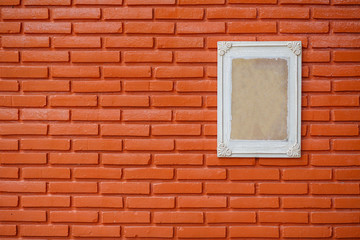 Fototapeta na wymiar Old wooden frame on the grunge brick wall
