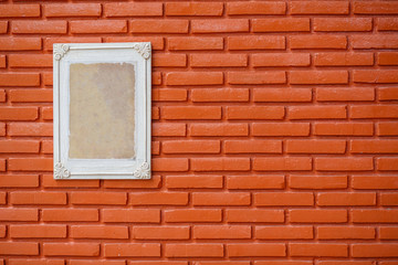 Fototapeta premium Old wooden frame on the grunge brick wall