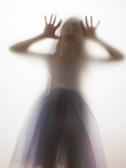 shadow of a girl behind transparent paper