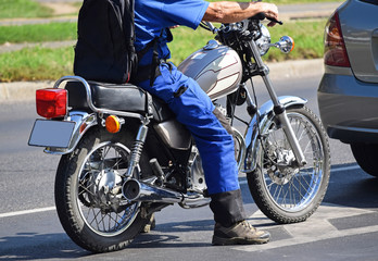 Obraz na płótnie Canvas Man with a motorcycle on the street