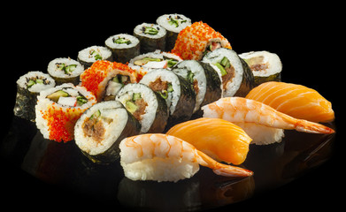 Delicious Sushi rolls with shrimp, salmon, tuna, cucumber and av