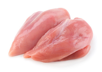Raw chicken fillets close up on white