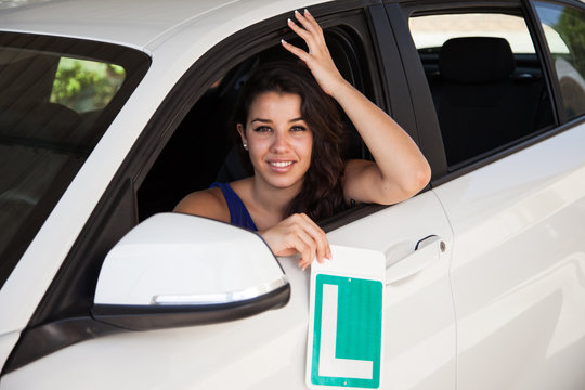 Tanned Brunette With Learner Plate In White Car