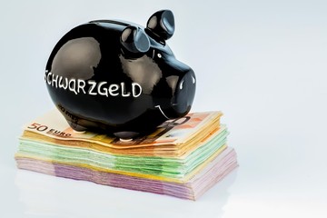 black piggy bank on money