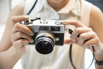 Hipster girl take a photo with vintage camera