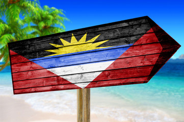 Antigua Barbuda Flag wooden sign on beach background