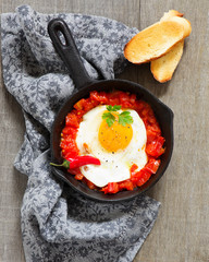 Scrambled eggs with roasted tomatoes.