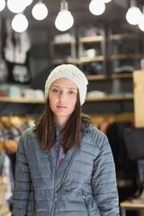 Serious pretty brunette looking at camera with winter clothes