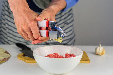 Man hands making stuffing for dumplings with meat
