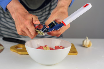 Man hands making stuffing for dumplings with meat