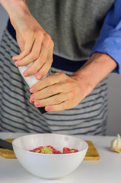 Man hands making stuffing for dumplings with meat