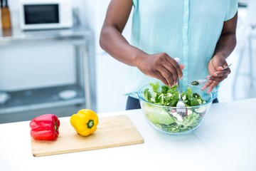 Midsection of pregnant woman having salad 
