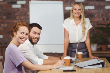 Portrait of happy business people during presentation in office