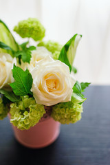 Beautiful flower composition with roses and hydrangeas in the vase 