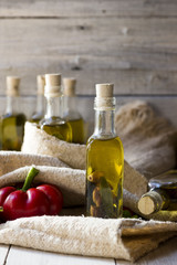 olives and olive oil in mini bottle on wood table