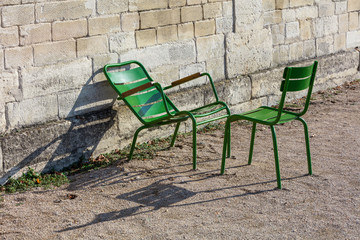 Two green garden chairs in the Tuileries Garden, Paris, France - 91125127