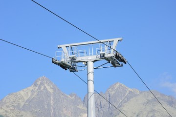 Chair lift mechanism with mountain in background