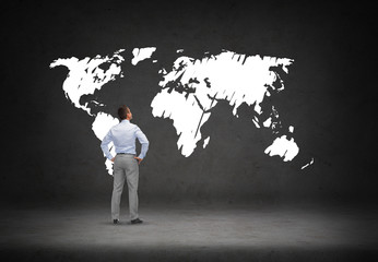 businessman looking at world map