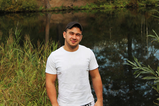 The guy in the white shirt in the background of the lake