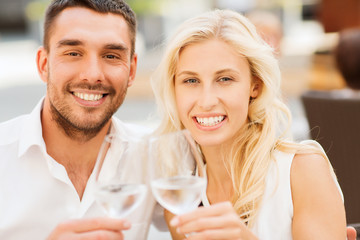 happy couple clinking glasses at restaurant lounge