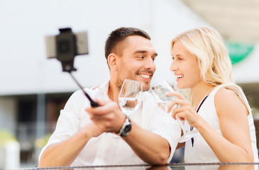 Fototapeta premium happy couple taking selfie with smartphone at cafe