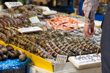 Man buying giant shrimps at fish market