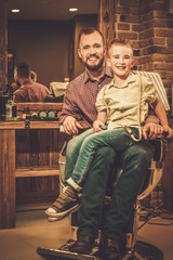 Stylish little boy and his father in a barber shop © Nejron Photo