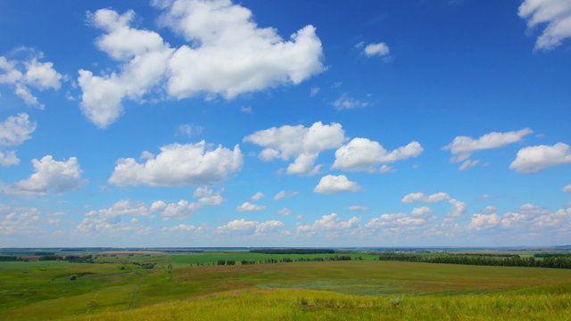 summer landscape with cloudy sky, view from hill, timelapse, zoom in
