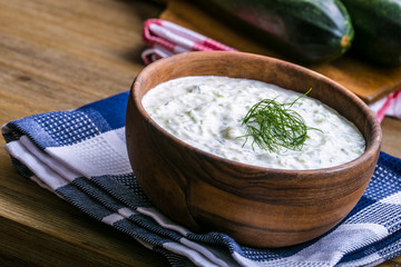 Tzatziki. Greek salad tzatziki  of cucumber, yogurt or cream, olive oil, garlic, dill and spices. Herb decoration of dill. 