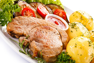 Fried steak, boiled potatoes and vegetable salad 