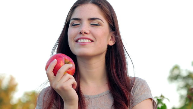 Portrait of smiling beautiful girl close up with apple