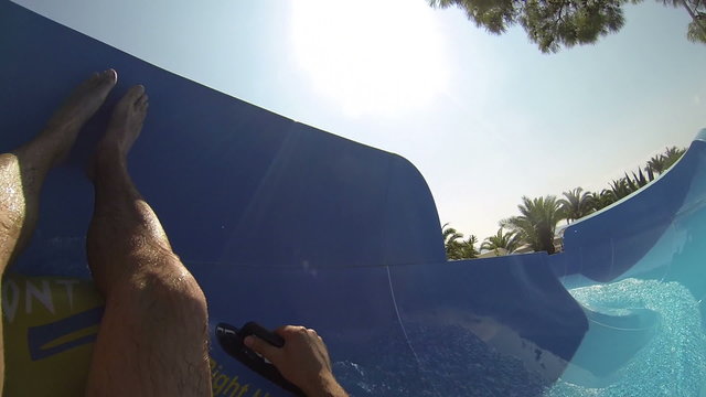 Crazy Race on the water slide in the water park. Slow motion.